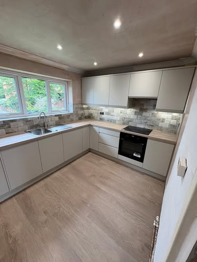 May be an image of kitchen island, cooker hood and indoors