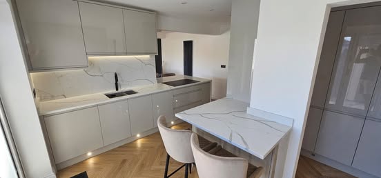 May be an image of cooker hood, kitchen island and indoors