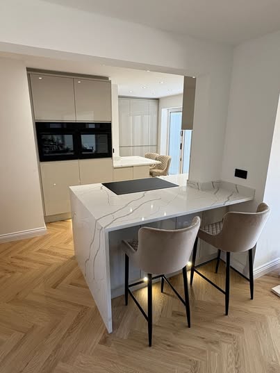 May be an image of cooker hood, kitchen island and indoors