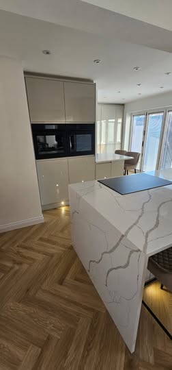May be an image of cooker hood, kitchen island and indoors